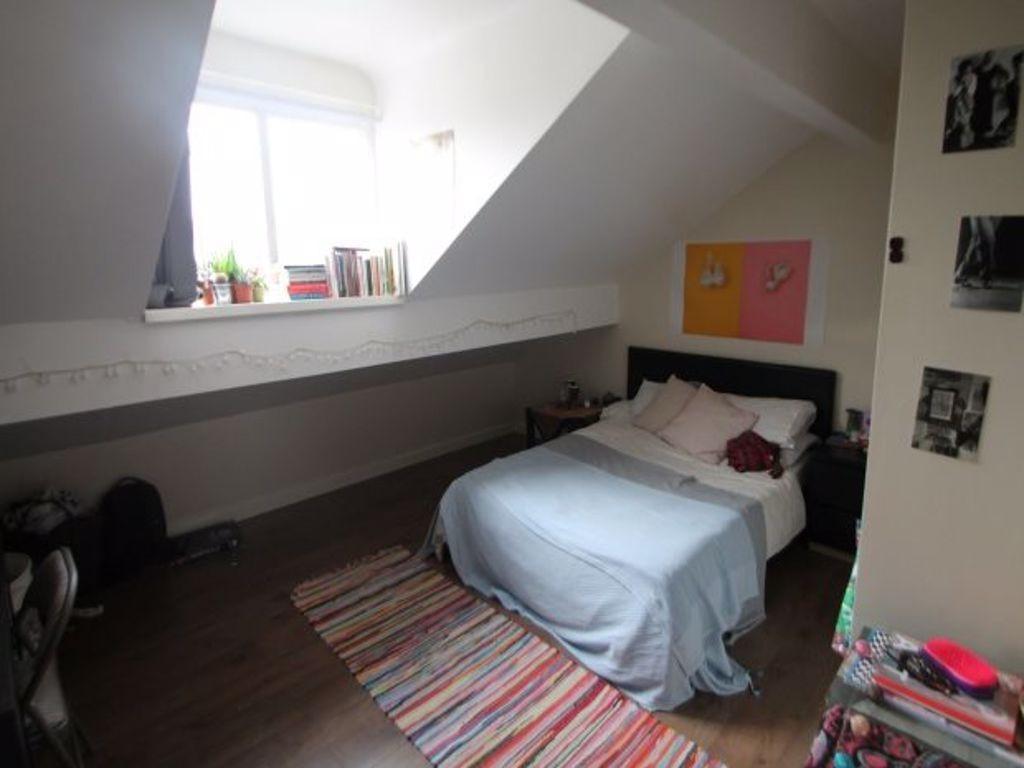 A cozy and inviting bedroom featuring a double ...