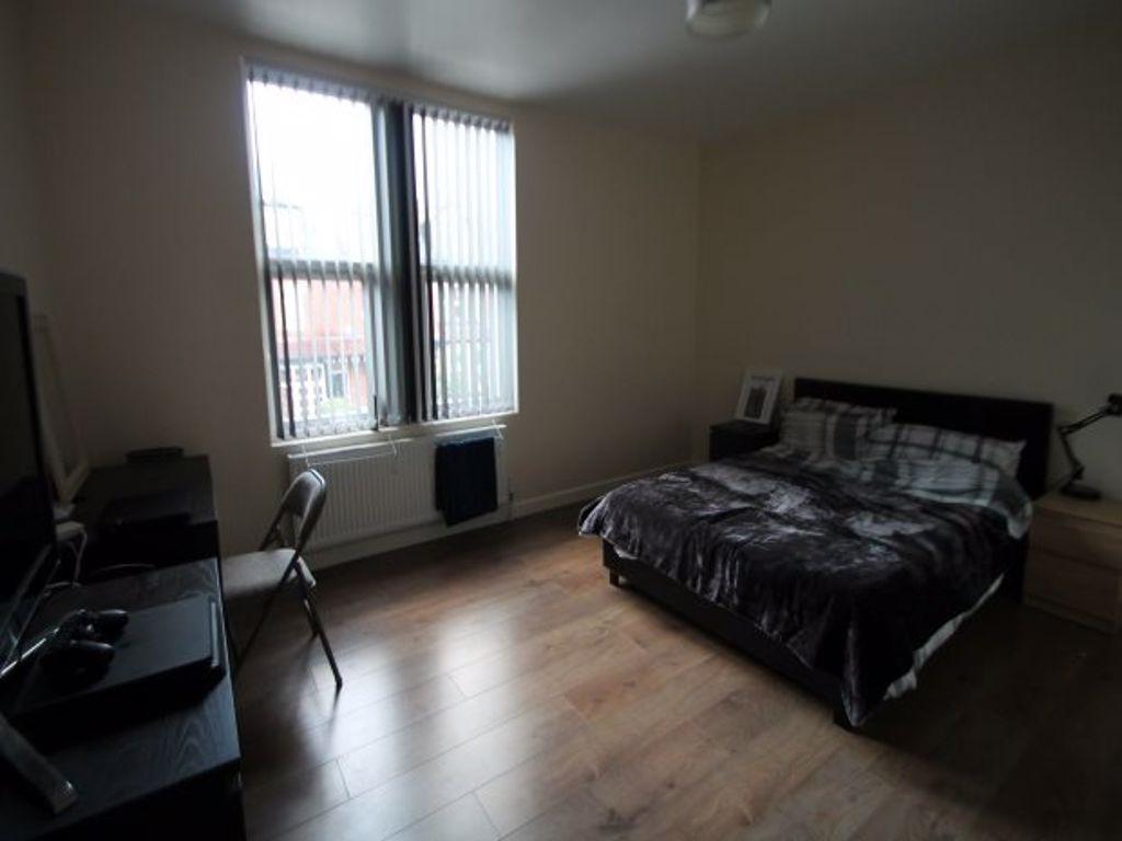 A spacious and well-kept bedroom featuring a la...