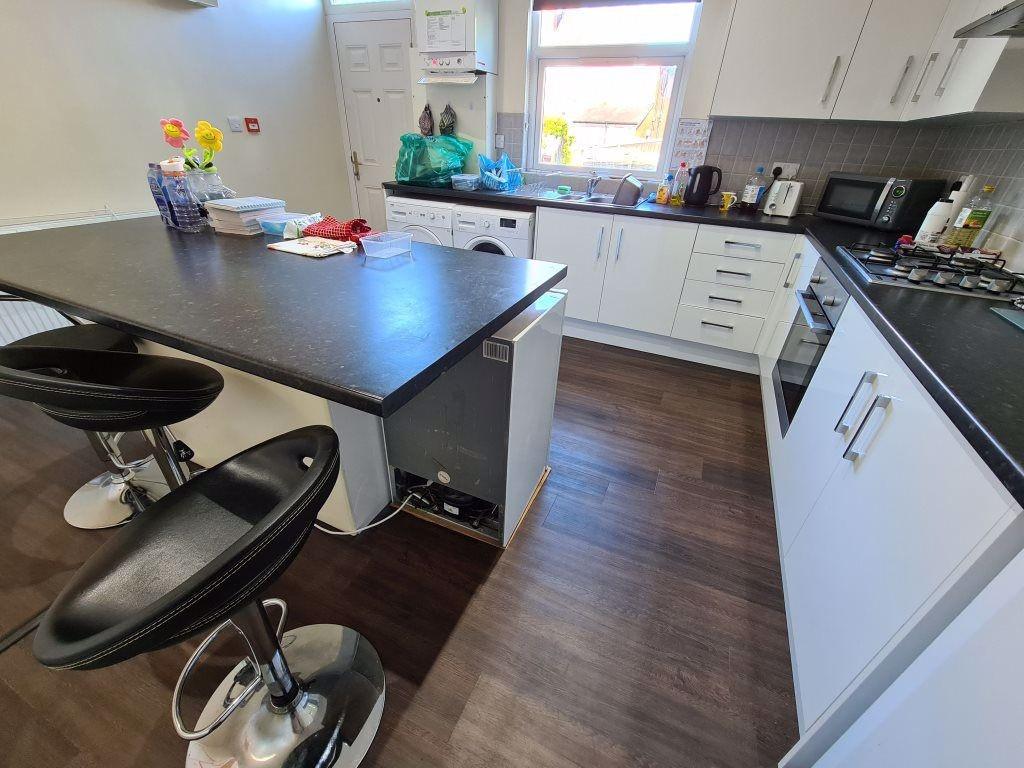 Bright and modern kitchen featuring ample count...
