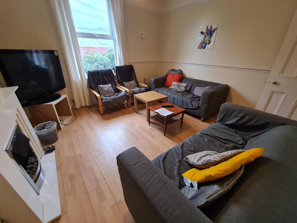 Bright, well-kept living room with wooden floor...