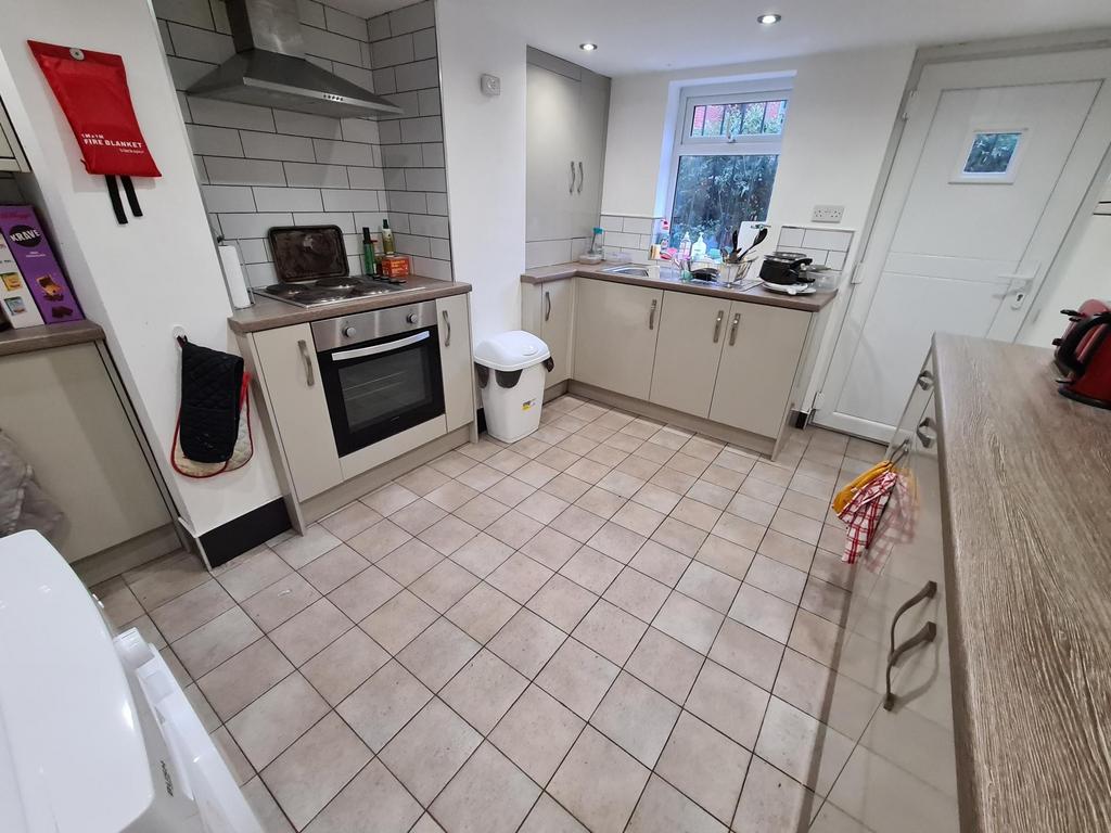 Bright, modern kitchen with tiled floor, integr...