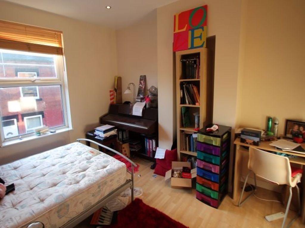 Bright and cozy bedroom featuring a large windo...