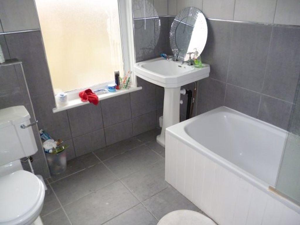 A modern bathroom suite featuring a clean white...