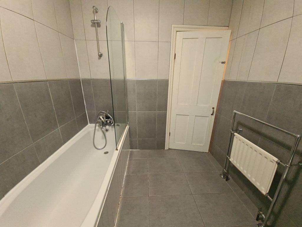 Spacious bathroom featuring a modern bathtub wi...