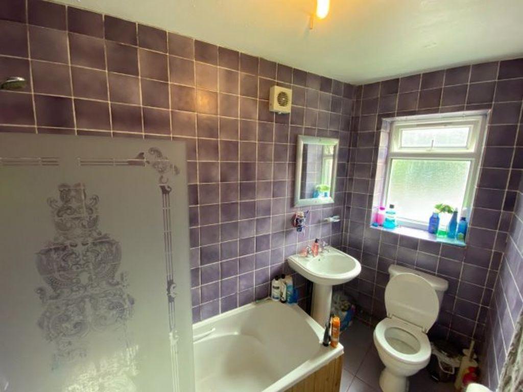A well-maintained bathroom featuring a bathtub ...