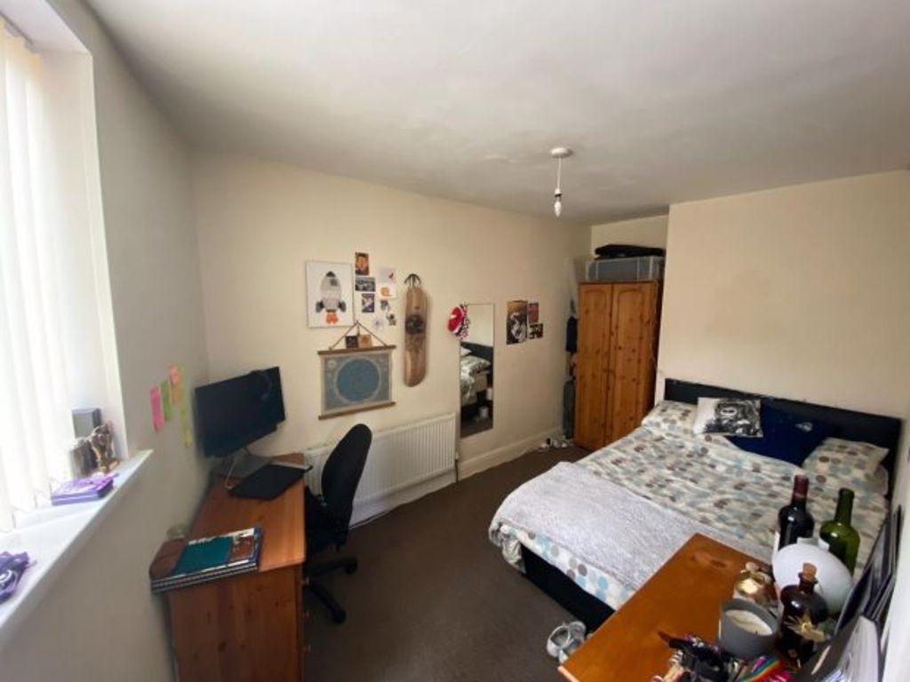 Bright double bedroom featuring a comfortable d...