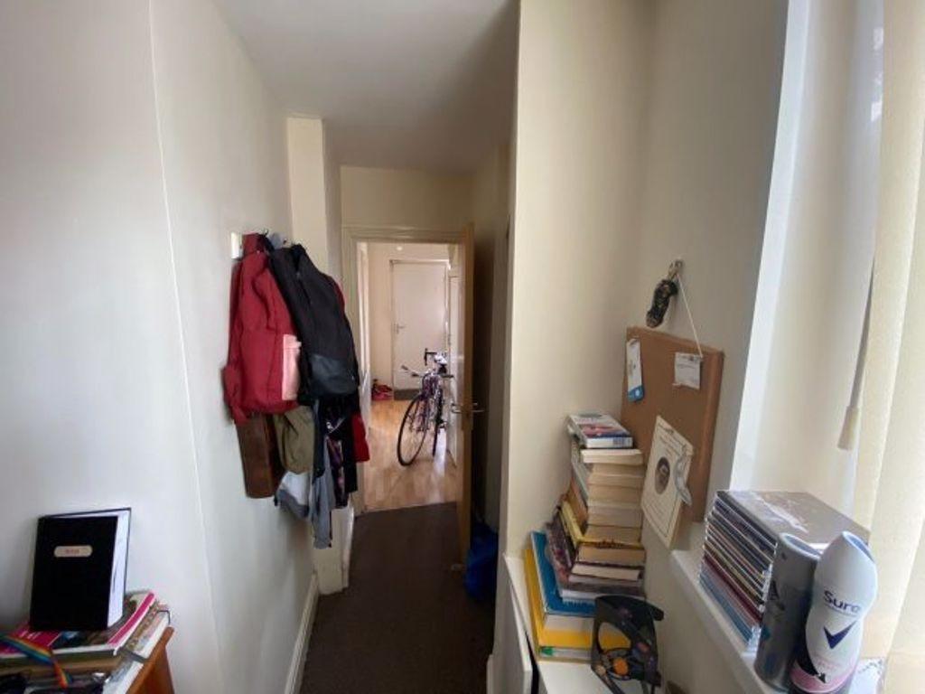 A narrow hallway with natural light coming thro...