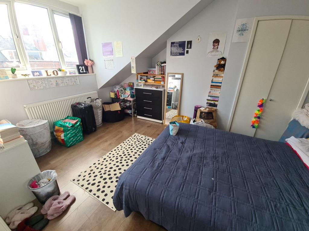 Bright and cozy master bedroom featuring a larg...