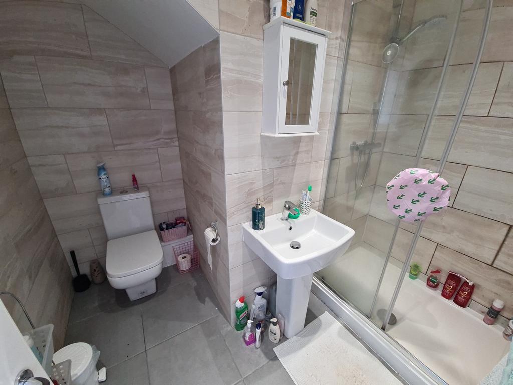 A clean and modern bathroom featuring a glass-e...