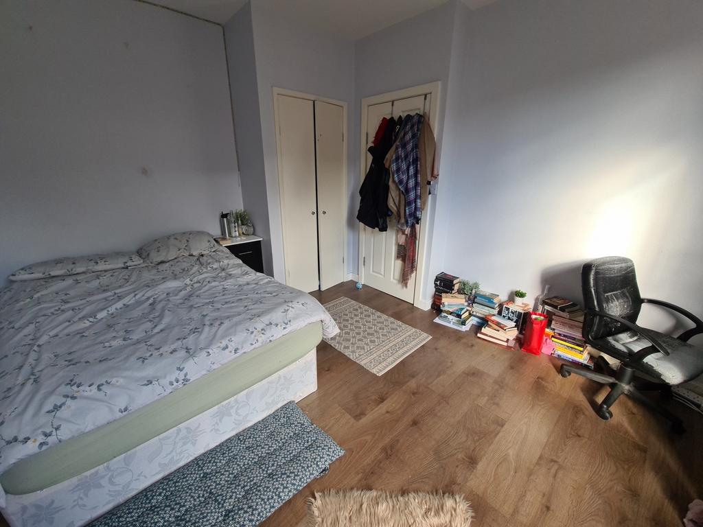 A clean and simple bedroom featuring a comforta...
