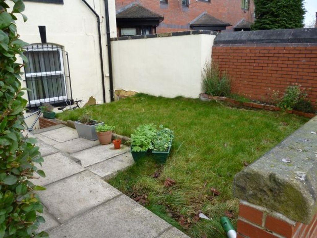 Well-maintained garden area with lush green gra...