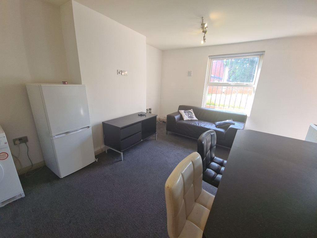 A bright and tidy living room featuring a large...