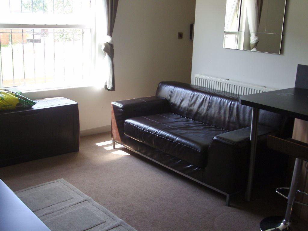 A cozy living room featuring a comfortable leat...