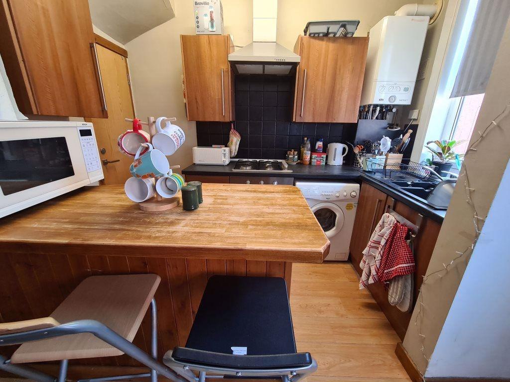 A compact and functional kitchen featuring wood...