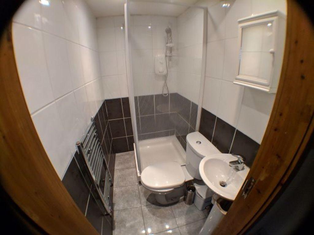 A modern bathroom featuring a clean white sink,...