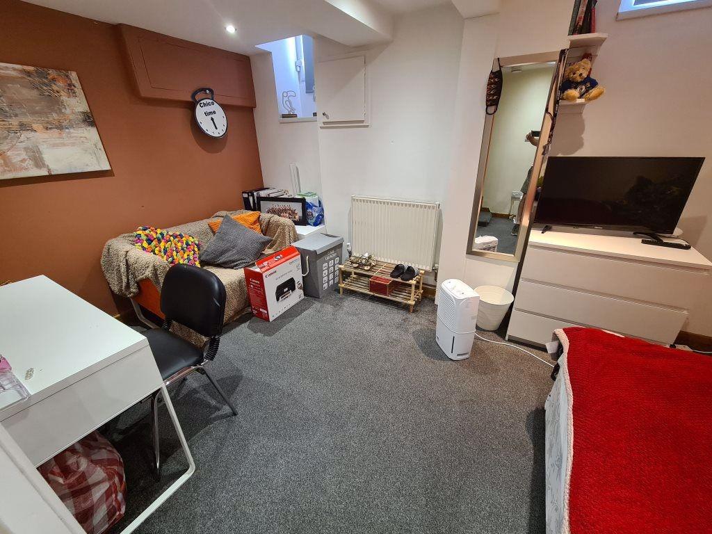A neat and functional small room featuring a co...