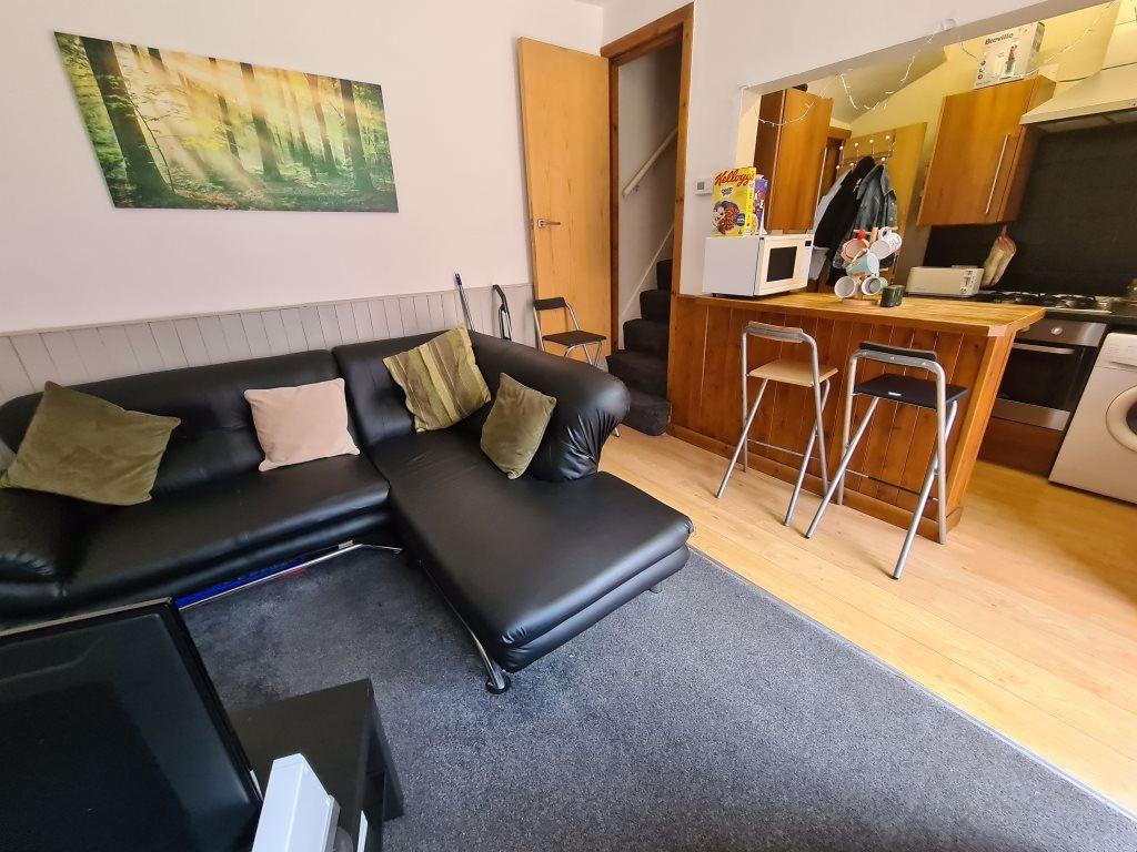 Bright and modern living area featuring a comfo...
