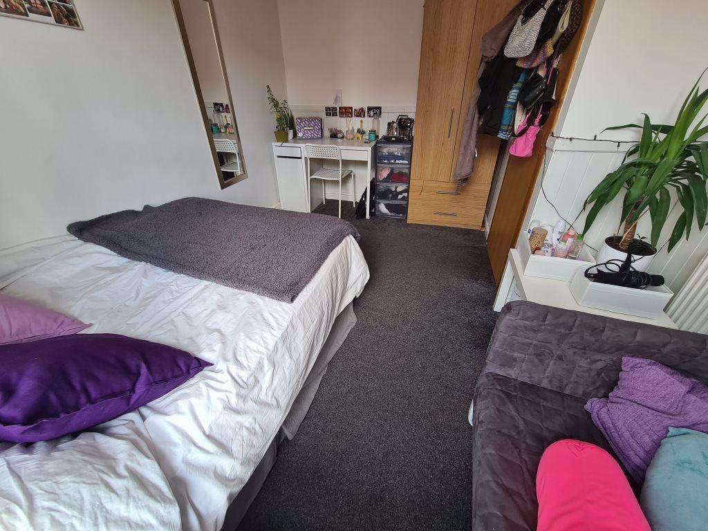 A cozy double bedroom featuring a neatly made b...