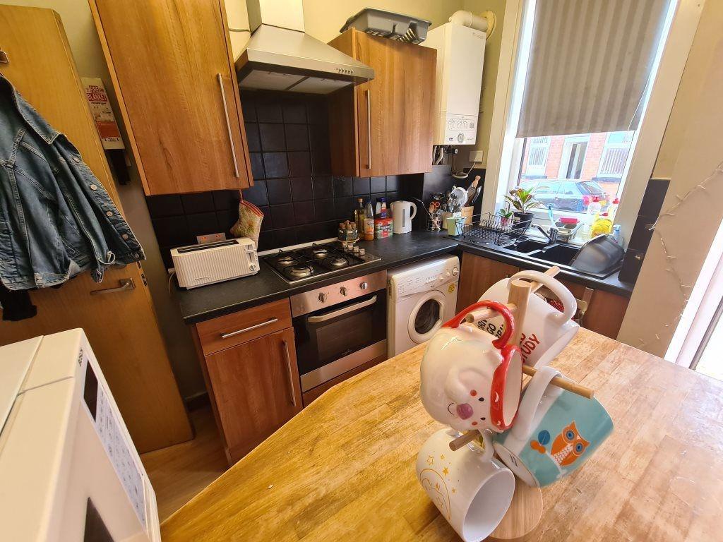 A compact and functional kitchen featuring wood...