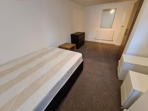 Simple, tidy bedroom with a comfortable bed, ne...