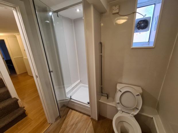 Compact, modern bathroom with a shower cubicle,...