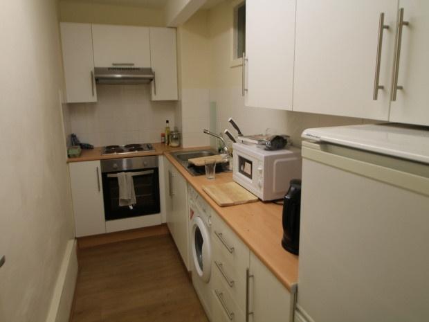 Bright, modern galley kitchen with wood-effect ...