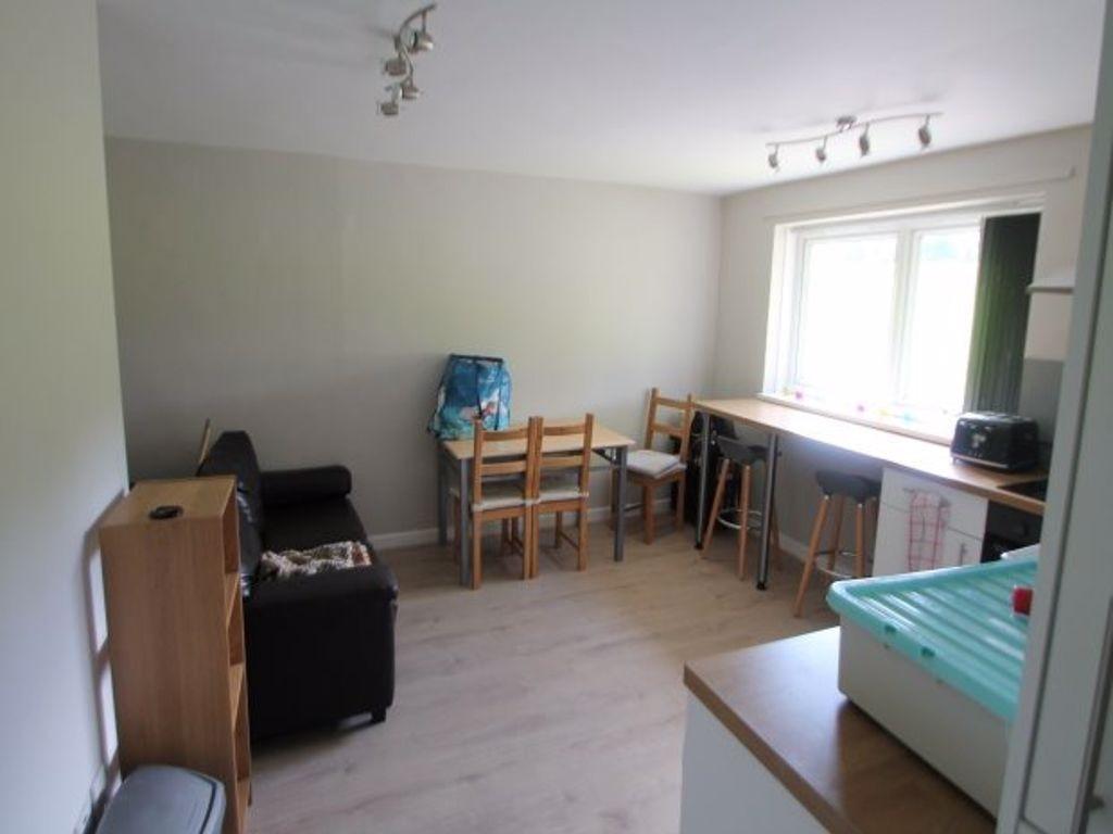 A bright and tidy living room featuring a large...
