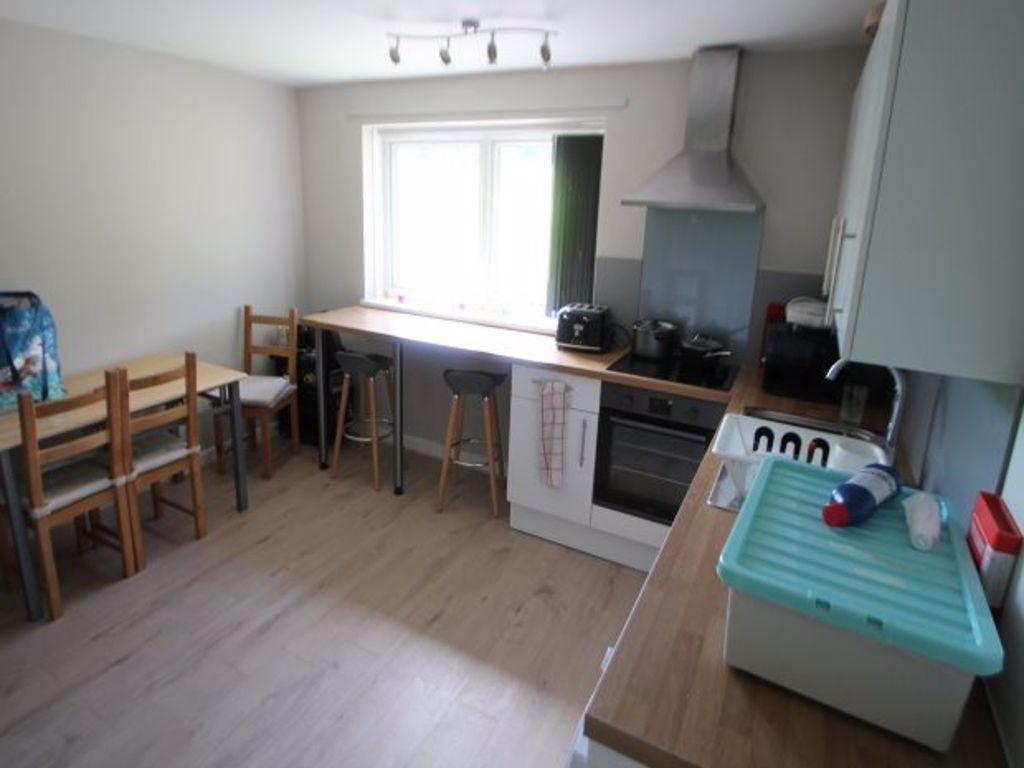 Bright and tidy kitchen featuring a large windo...
