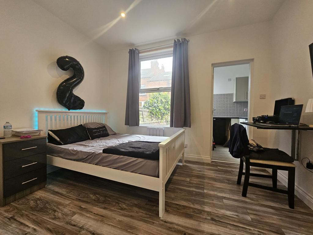 A bright and tidy double bedroom featuring a wh...