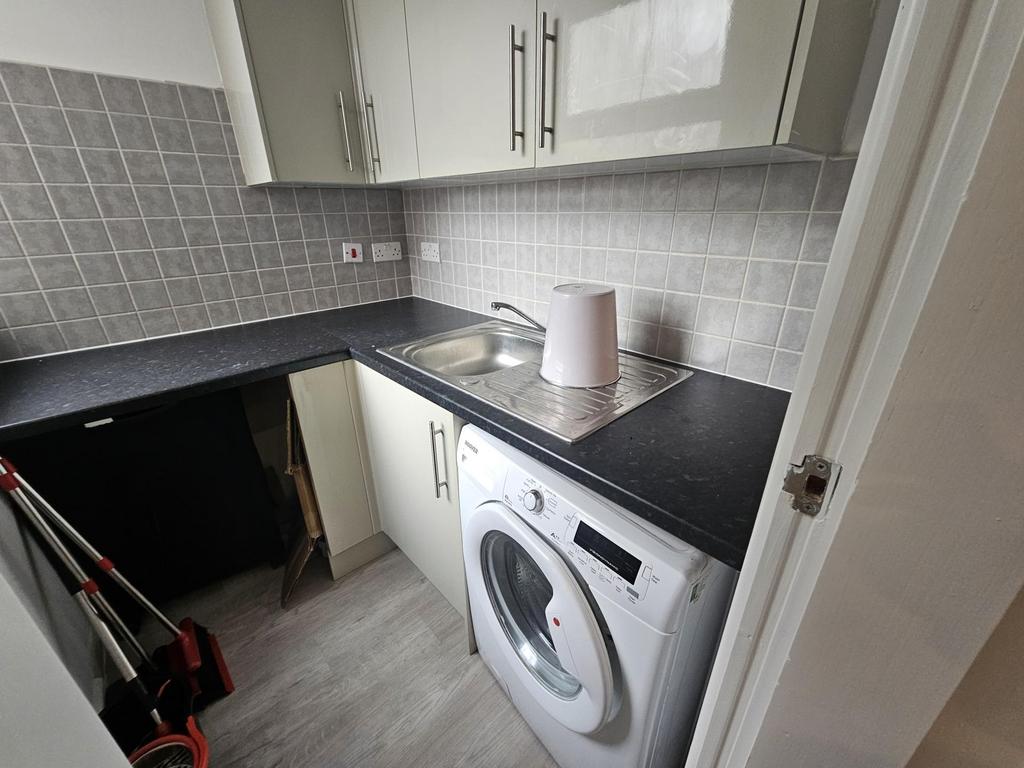 Compact and tidy kitchen featuring modern cabin...