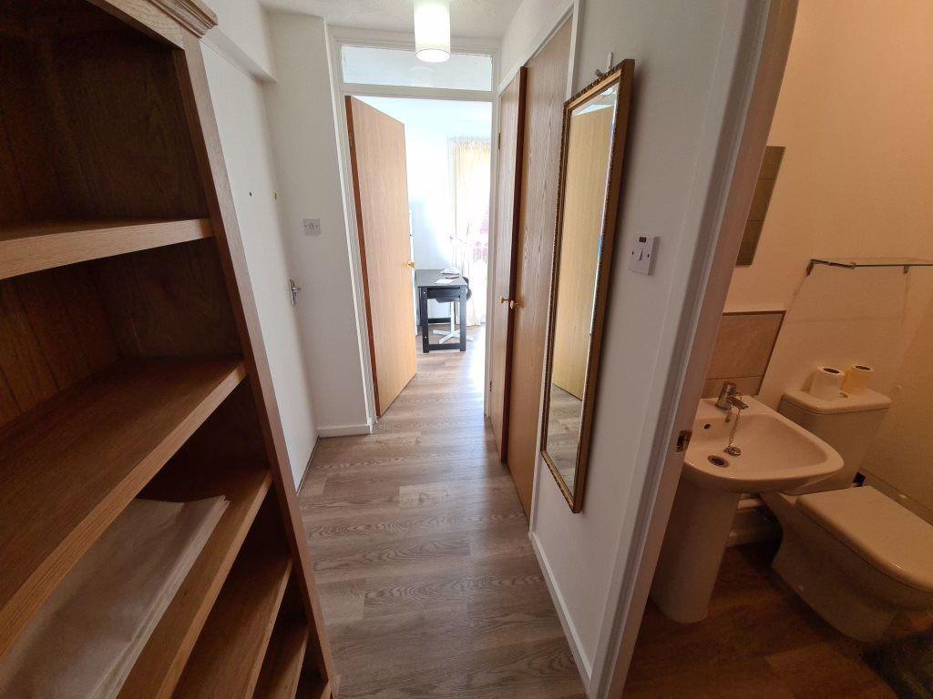A clean and tidy hallway with light-colored woo...
