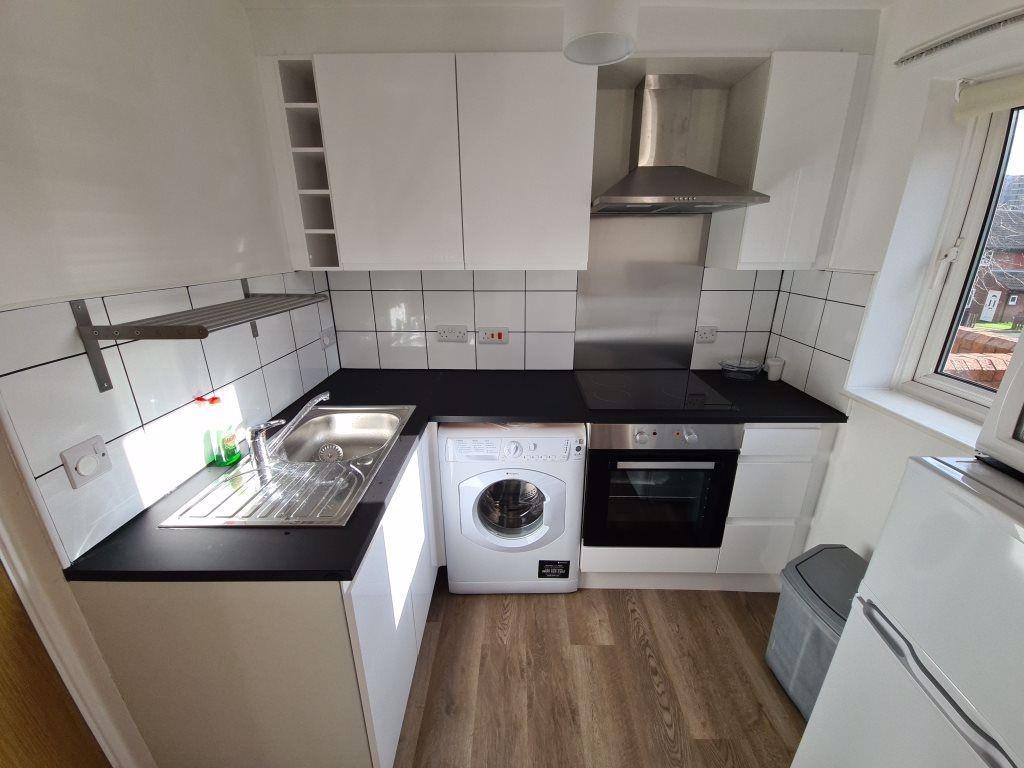 Bright and modern kitchen featuring sleek black...