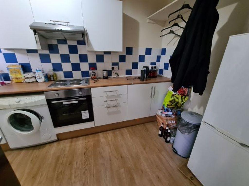 Bright and tidy kitchen featuring modern applia...