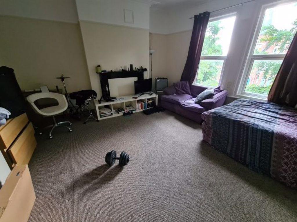 A spacious and inviting bedroom featuring a lar...