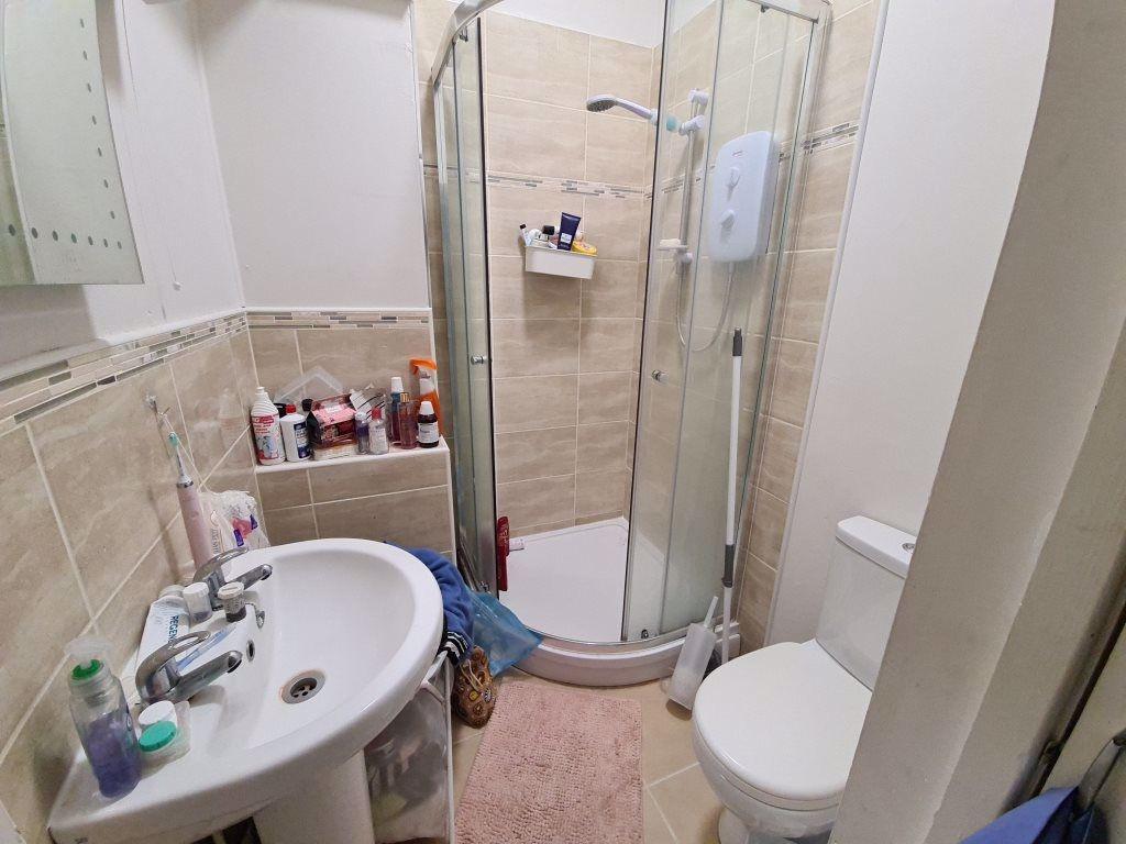 Bright, modern bathroom with a corner shower, p...