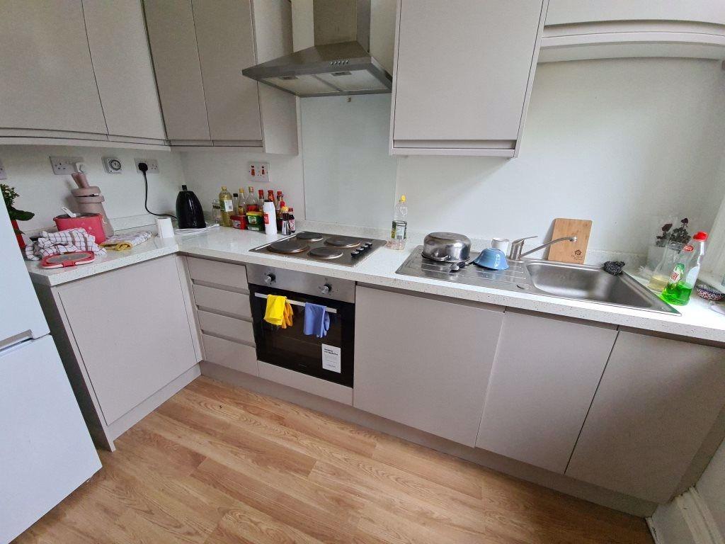 Modern fitted kitchen with integrated oven, ele...