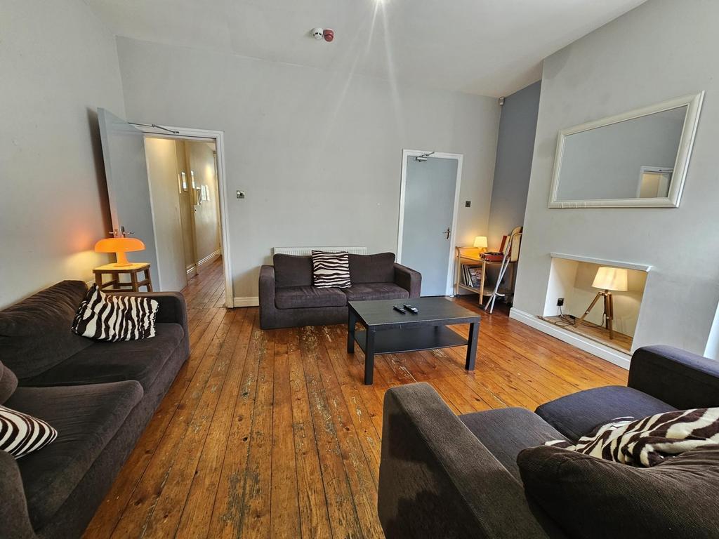 Bright, welcoming living room with wooden floor...