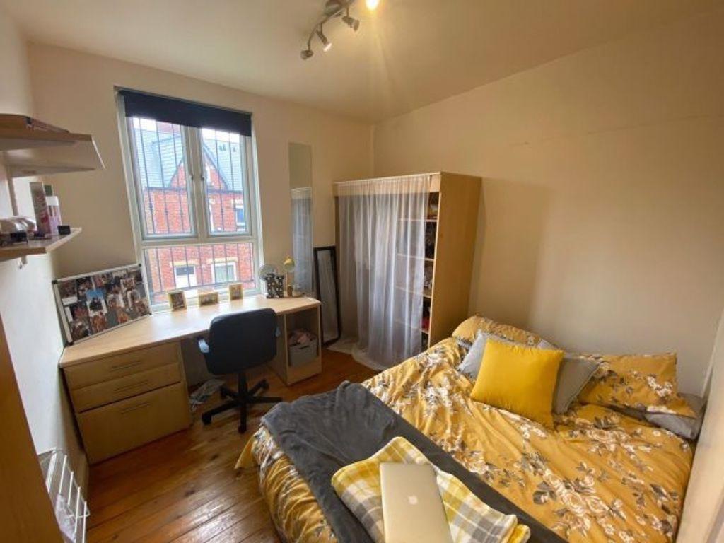 Cozy double bedroom featuring a comfortable bed...