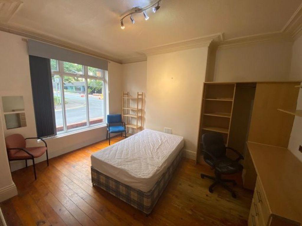 Bright double bedroom featuring a large window ...