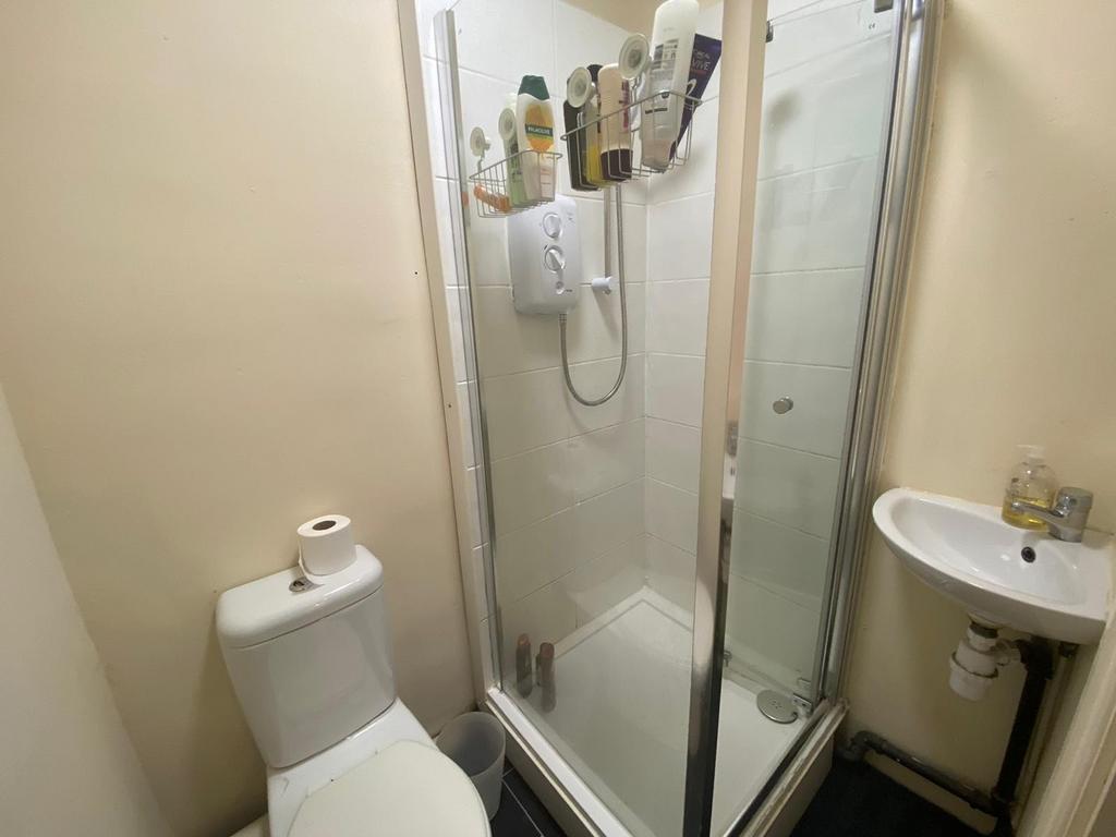 A clean and modern bathroom featuring a glass-e...
