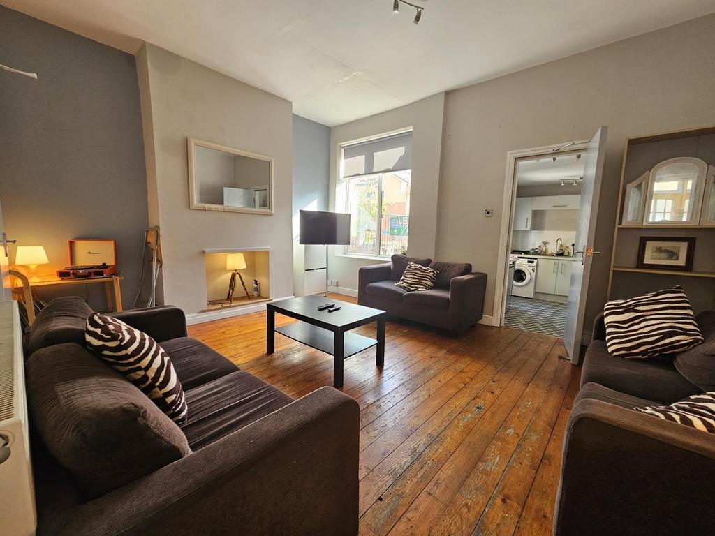 Bright, welcoming living room with wooden floor...