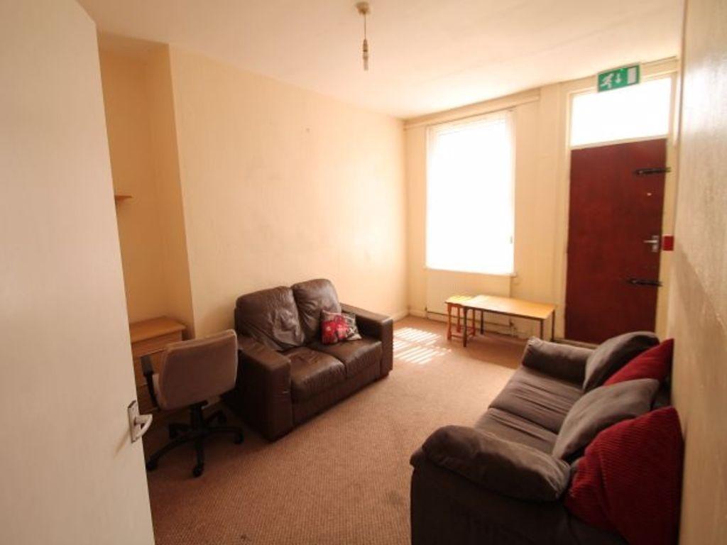 A cozy communal lounge with two comfortable sof...