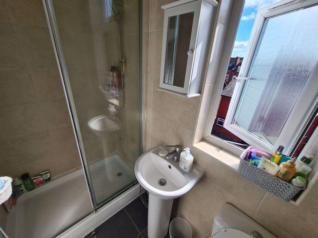 A clean and modern bathroom featuring a glass-e...