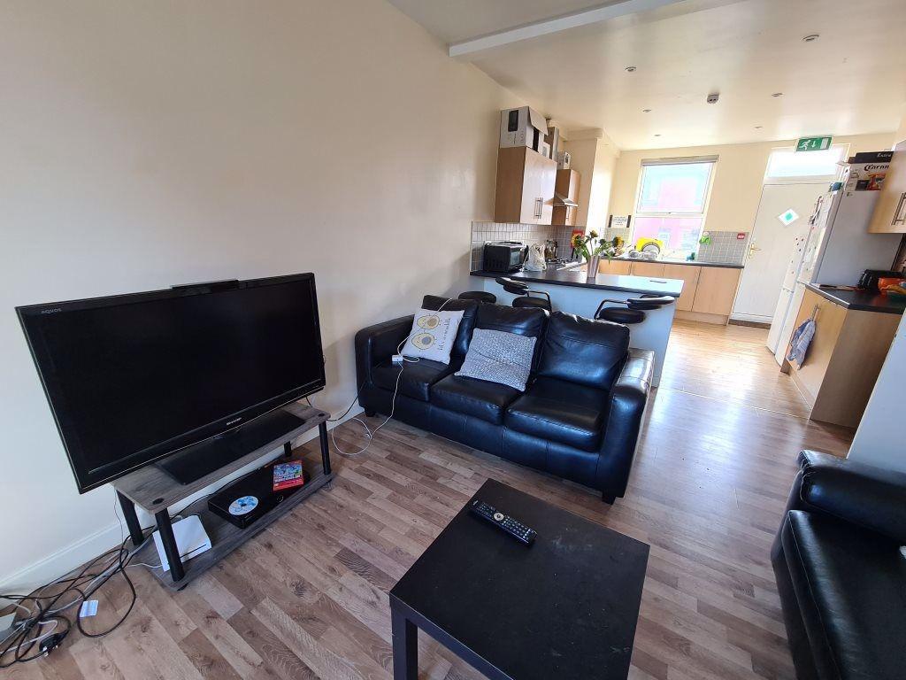 A cozy and well-lit living room featuring a com...