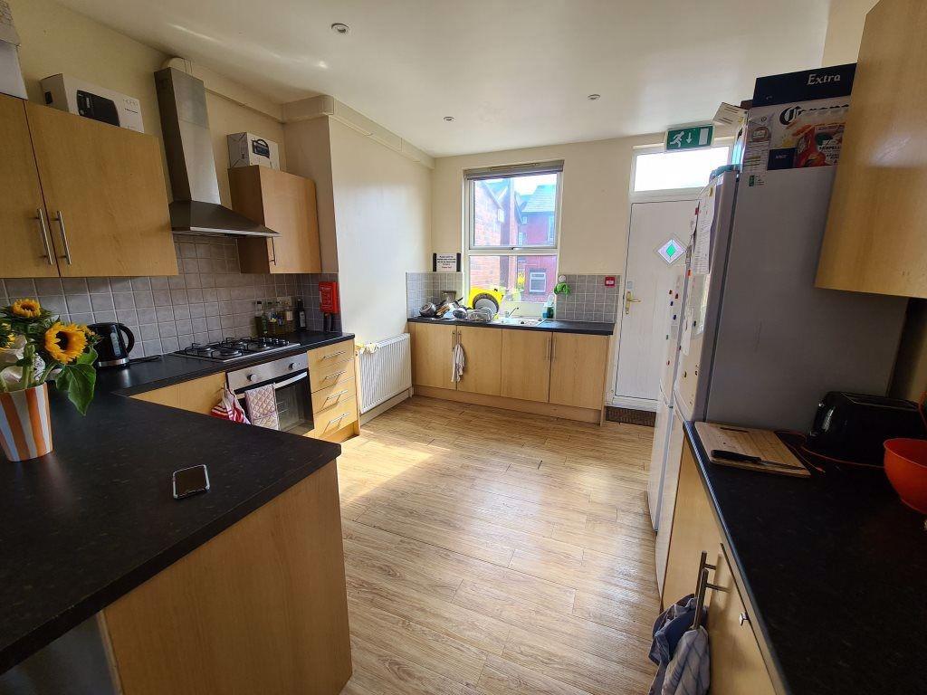 Bright and well-organized kitchen featuring amp...
