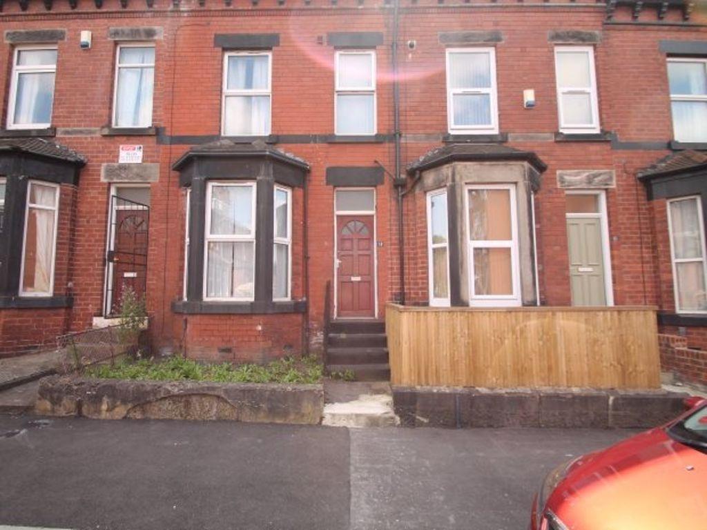 A classic red-brick terraced house with large b...