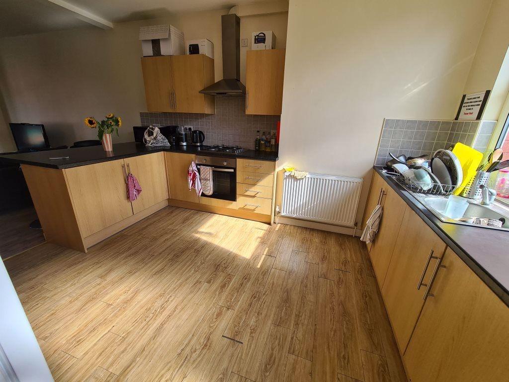 Bright and tidy kitchen with wooden floors and ...