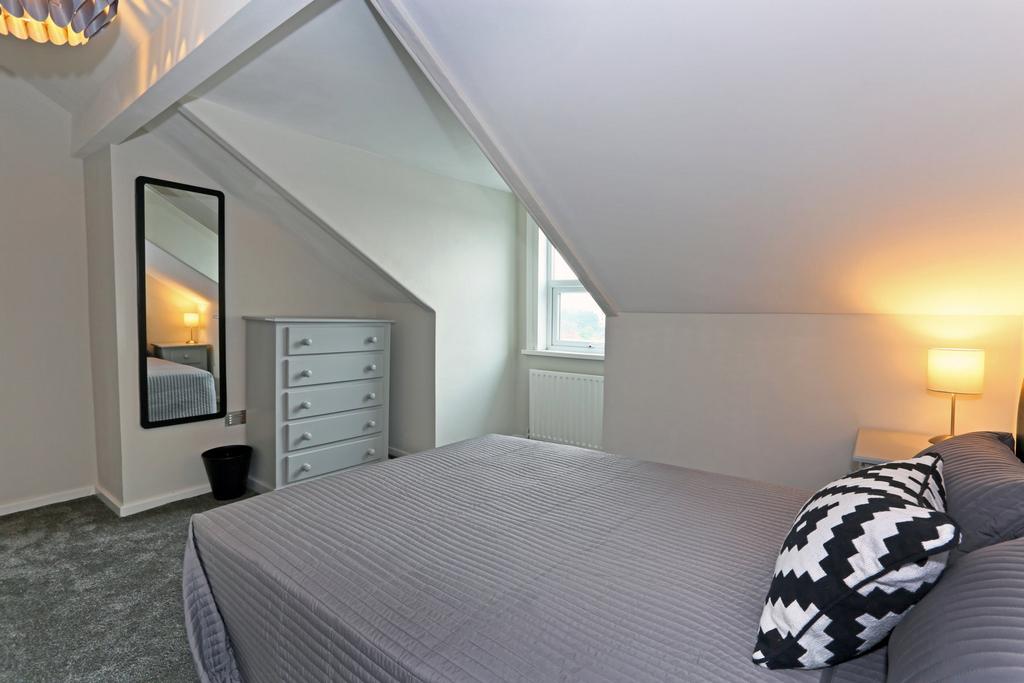 A cozy and well-kept master bedroom featuring a...