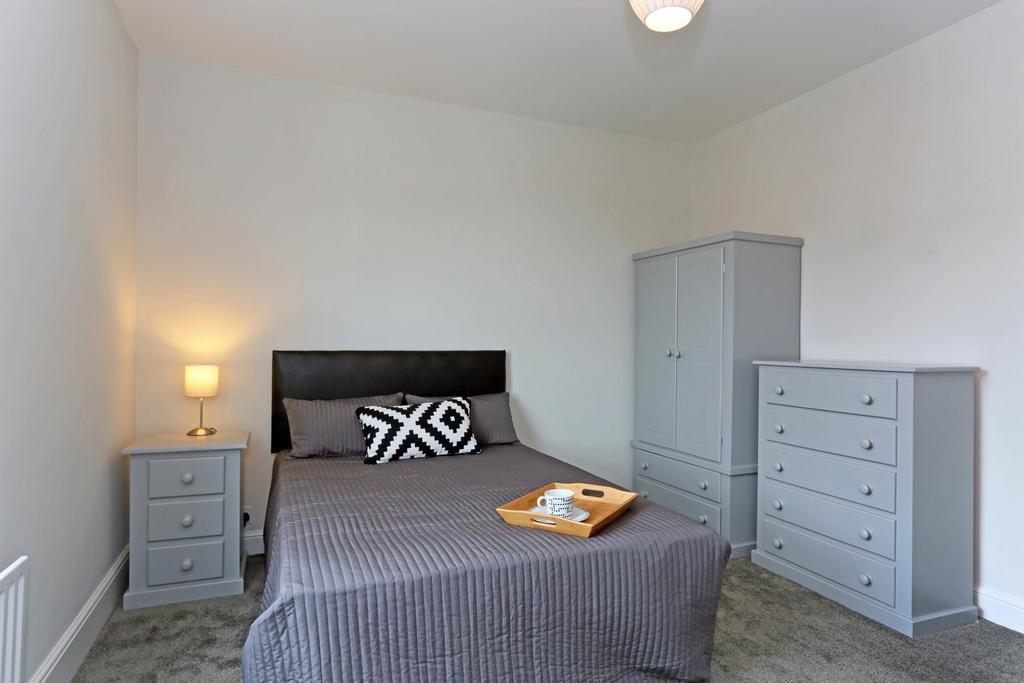 A cozy double bedroom featuring a comfortable d...