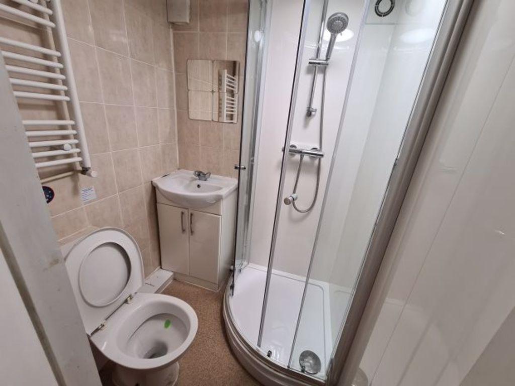 Clean and modern bathroom with a shower enclosu...